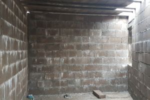 With the beam and block floor in place, the lower ground floor rooms now appear darker and more enclosed. This will be the utility room; the sink unit, worktop with washing-machine underneath and cupboards will be installed along this wall.