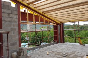 A similar timber frame is being constructed above the other south-facing window.