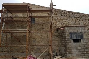 In this picture you can see the difference between the stonework before pointing (on the right) and after pointing (behind the scaffolding).