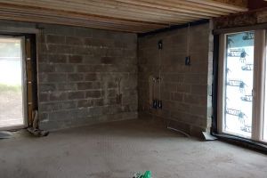 This is the south-east corner of the kitchen. The main units will be installed here, between the window and door: sink on the left, mid-level ovens on the right, with worktop and cupboards inbetween. An L-shaped island unit will be in the foreground: the hob will be on the section facing out to the room; the rest will be workspace. In the original plans the far end of this space - and the tall window on the right - were walled off, making an extra room. We didn't really need this room, so we decided to remove the wall and make the whole space into the kitchen. We're glad we did as the long window will now be part of the main room and will bring extra daylight into the kitchen.