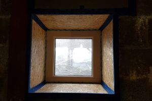 The lower floor bathroom window. The reveals have been boarded with OSB and then taped. It wasn't possible to splay the reveals in this room; it shows the 'tunnel' effect if they're not splayed.