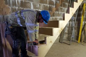 Iain the carpenter, hard at work fitting the treads and risers to the stairs.