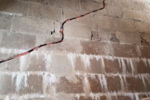 This unconventionally shaped conduit was chased out by Mike for the stair light wiring. Short sections of blue conduit have been inserted in the holes where the lights will go, linked by flexible black conduit to carry the wires.
