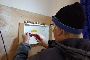 And the first thing Mike fixes to the board is the consumer unit. All of the main house wiring starts and finishes here.