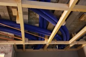 By the time all the feeds and extracts to the bedrooms and bathrooms are in, the suspended ceiling has become a spaghetti junction of blue flexible ducting.