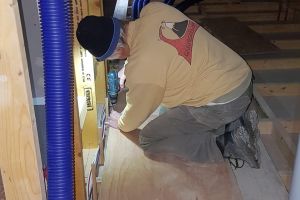 Then he sets to work building a raised walkway in the entrance to the attic, which will both cover and protect the ducting.