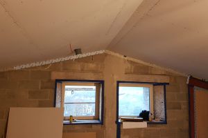 The newly plasterboarded ceiling above the mezzanine. This space will be divided in two by a stud-partition wall. The area on the left will be an office; the area on the right will be a sitting area overlooking the main room. Both will have great views from the windows.