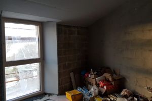 Guest bedroom: window boarded on three sides; ceiling and stud-partition wall plasterboarded.