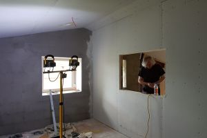 The plasterboard is installed on the office side first.