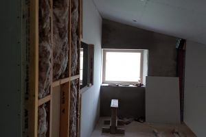 A thin layer of insulation is installed next (this is for sound insulation) and then plasterboard goes on top.
