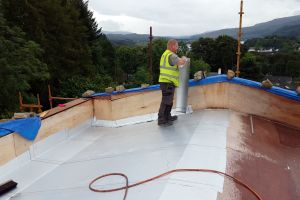 Towards the end of August, the roofers arrive and set to work. First, they apply a waterproof membrane directly to the boards.
