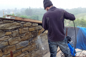 Frankie the stonemason cleans a section of the north wall before final pointing begins.